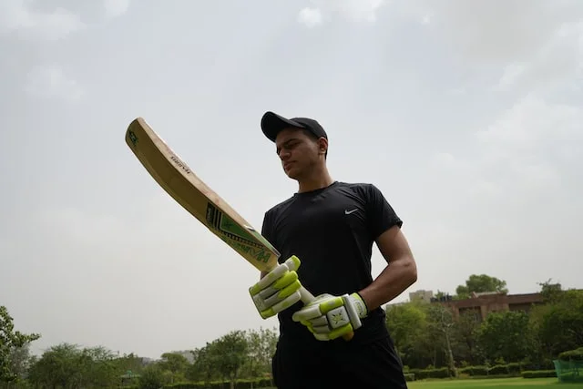 a person holding a cricket bat